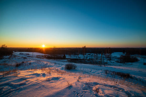 istock colorful sunset light over fields of snow in winter 1143195404