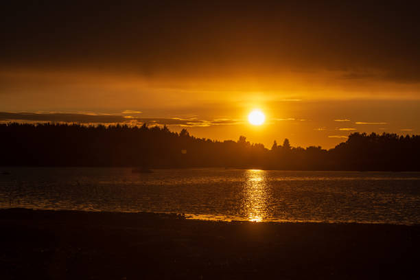 istock dark red sunset over sea in evening 1143195819