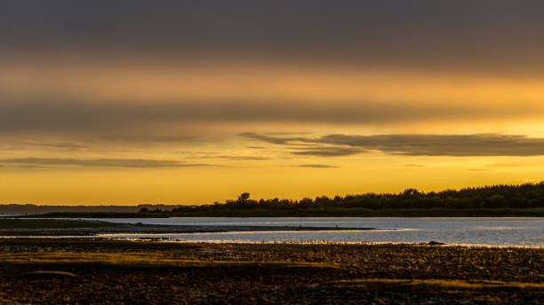 istock dark red sunset over sea in evening 1143195822