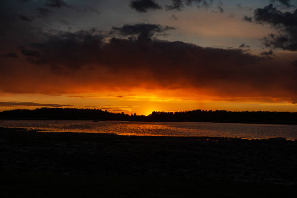 istock dark red sunset over sea in evening 1143195832