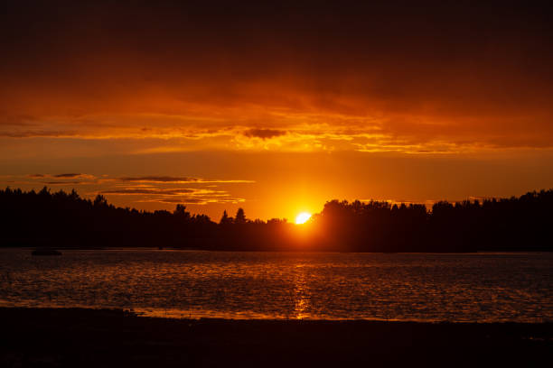 istock dark red sunset over sea in evening 1143195834