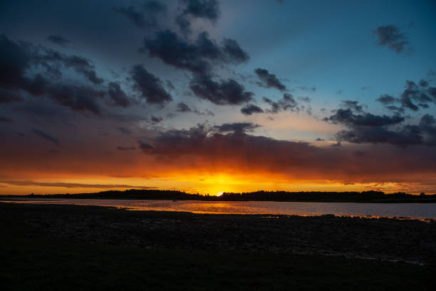 istock dark red sunset over sea in evening 1143195853