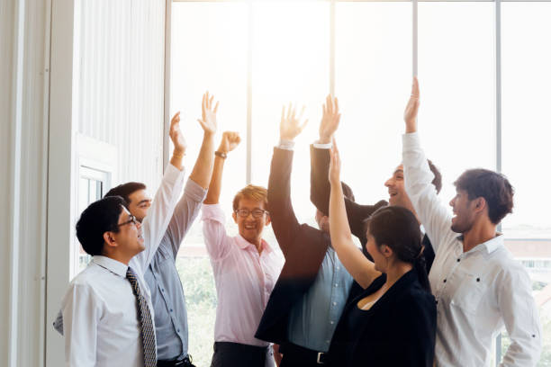 istock Cheerful diverse business people holding arms raised 1143195883