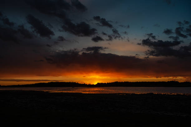 istock dark red sunset over sea in evening 1143196439