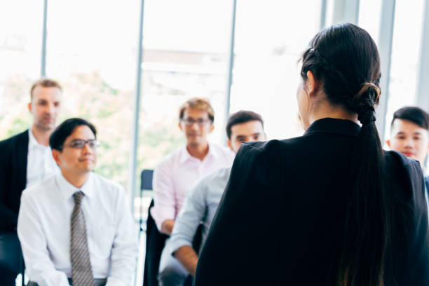 istock Female leader doing presentation for coworkers 1143196453