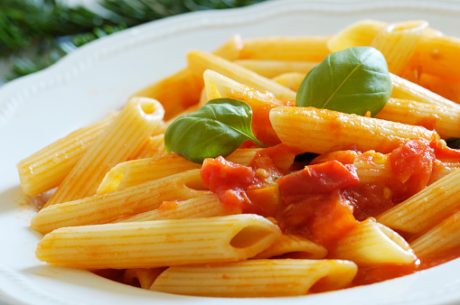 Penne pasta with a sauce made of cherry tomatoes, garlic, extra virgin olive oil and basil
