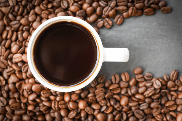 istock coffee cup on roasted coffee beans on the dark background top view 1143199102