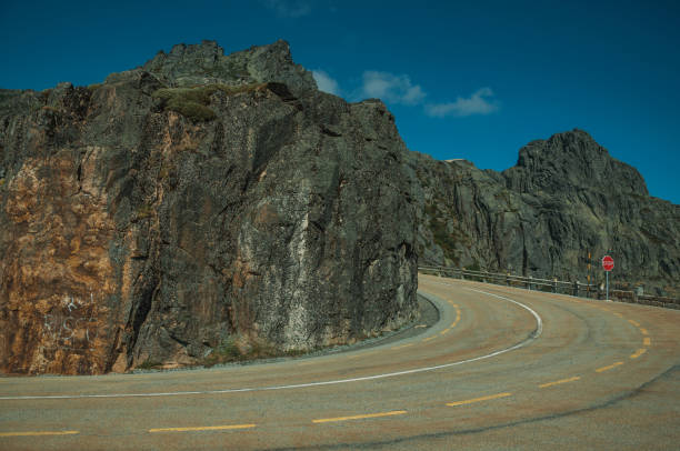istock Roadway on rocky landscape with STOP traffic signpost 1143200131