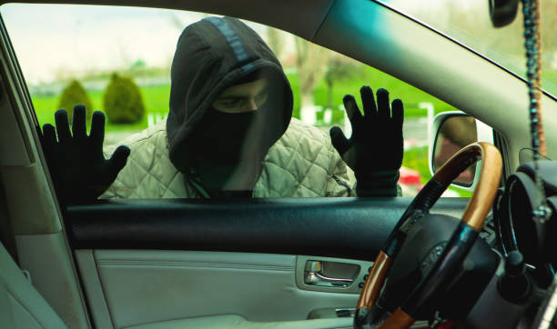 istock Hooded thief looking to break into a car 1143201308