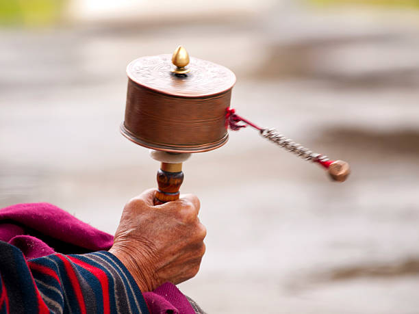 Older women spinning her prayer wheel stock photo