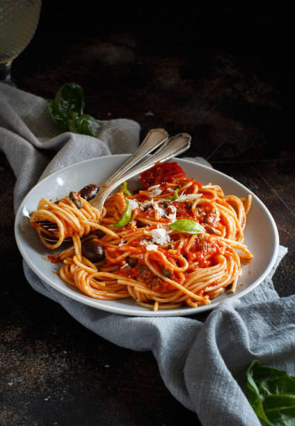 istock Spaghetti with tomato sauce olives and capers 1143207263