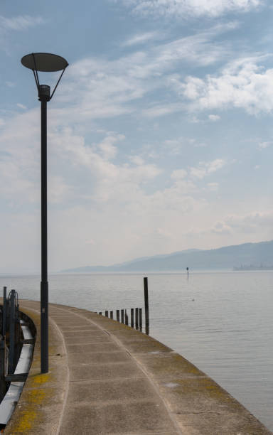istock harbor pier and jetty with a great lake view and a lantern in the foreground 1143207302