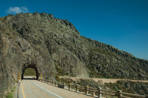 istock Road on rocky landscape passing through tunnel 1143208433