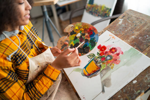 istock Young afro woman drawing 1143209599
