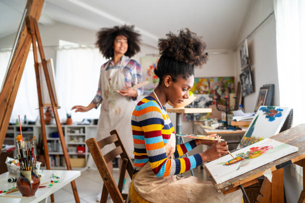 istock Afro Female fine artists drawing in studio 1143209609