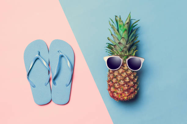 istock pineapple on colored paper with glasses 1143209686