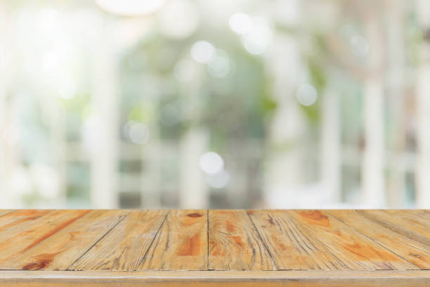 istock Empty wood table top and blurred of interior room with window view from green tree garden background background - can used for display or montage your products. 1143209717