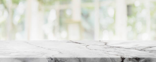 istock Empty white marble stone table top on blurred with bokeh shopping mall and restaurent interior banner background - can be used for display or montage your products 1143209747
