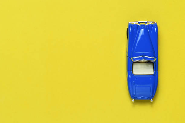 istock Toy car on yellow background top view 1143209942