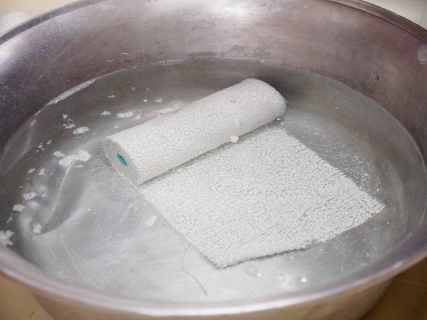 Roll of plaster bandages in water for bone fractures stock photo