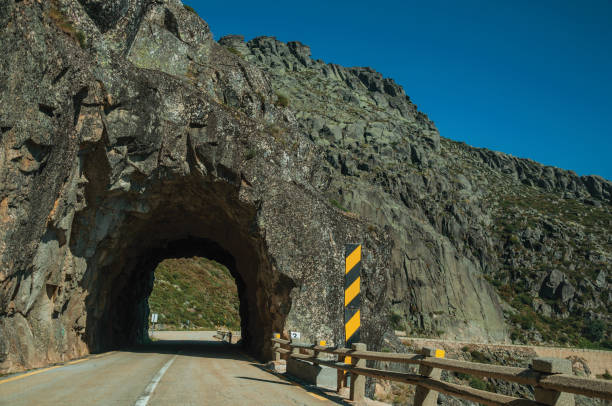 istock Road on rocky landscape passing through tunnel 1143210664
