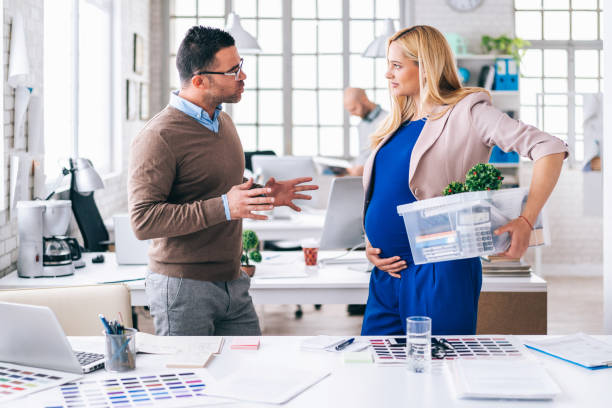 Pregnant woman in office, ready for maternity leave Pregnant woman in office, ready for maternity leave unwanted pregnancy stock pictures, royalty-free photos & images