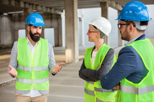 istock Bearded young architect is explaining project details and future plans to his colleagues 1143212369