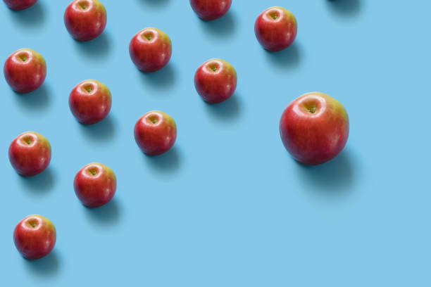 istock Juicy ripe red apples on a blue pastel background. 1143212799