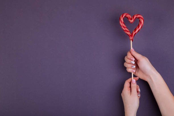 istock Lollypop on a stick in hand. 1143213744