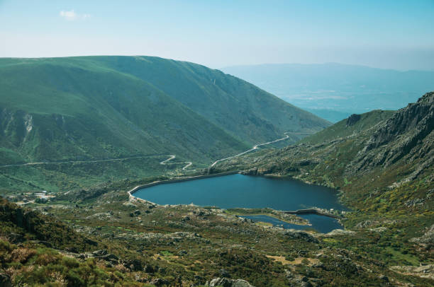 istock Blue water at dam lake on hilly landscape 1143214016