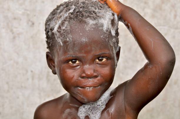 istock Close-Up Portrait Of Shirtless Boy Taking Bath 1143214601