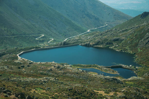istock Blue water at dam lake on hilly landscape 1143217344
