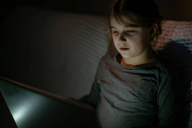 istock Smiling little girl using laptop 1143223387