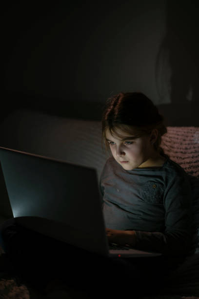 istock Smiling little girl using laptop 1143223482