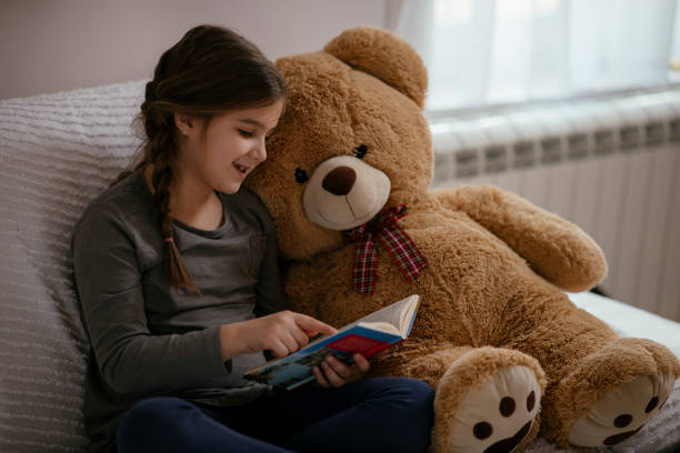 istock Little child girl is reading a book 1143223703