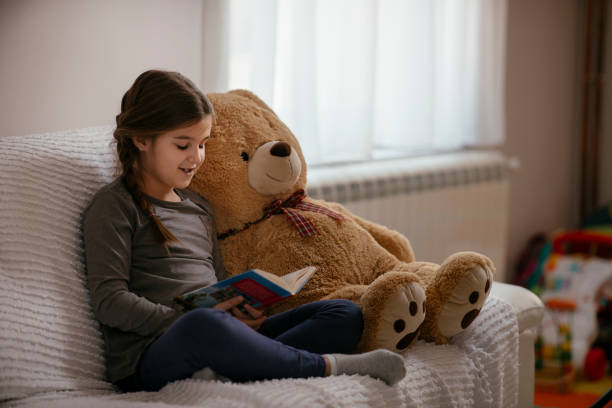 istock Little child girl is reading a book 1143223734