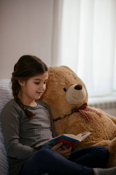 istock Little child girl is reading a book 1143223822