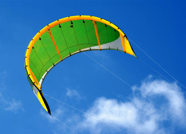 Green and yellow sail. Windsurf cloth inflated by the wind on a background of blue sky. kiteboarding stock pictures, royalty-free photos & images