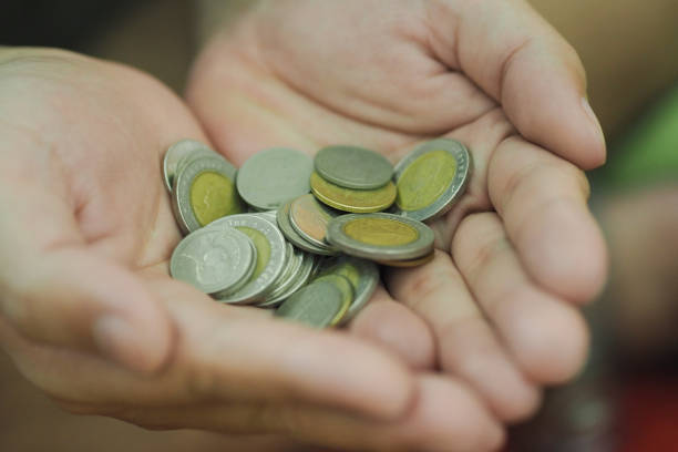 istock Soft Focus Thai Baht Coin in Your hand 1143229988