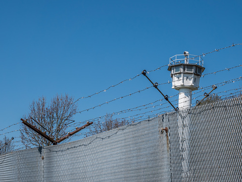 Metal fence with barbed wire