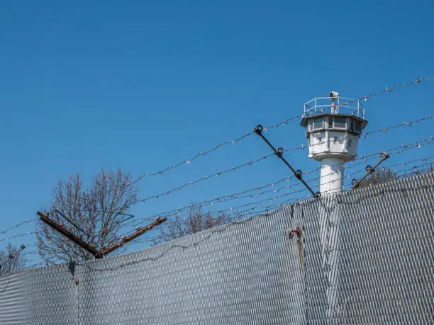 Barbed wire fence with German watchtower border