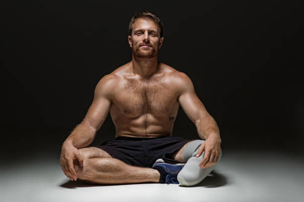 Portrait of a Young Man With Sunglasses and Undershirt Flexing Muscles - Isolate on Black Blackground - Copy Space