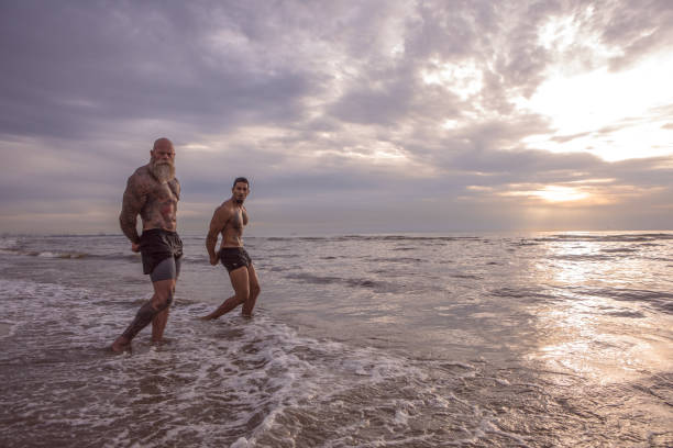 istock Tattooed Senior Man coaching young man During Workout 1143233119