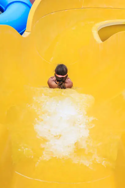 Girl having fun sliding in a waterpark