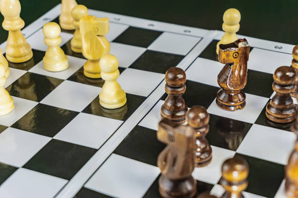 istock white and black chess on the Board 1143233327