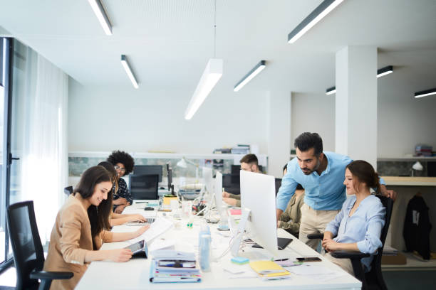 istock Business person supervising and helping his team. 1143233396