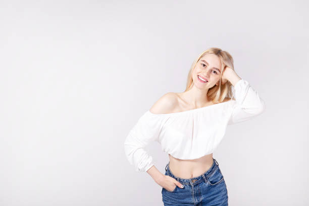 istock Attractive young woman posing over grey background. 1143233446