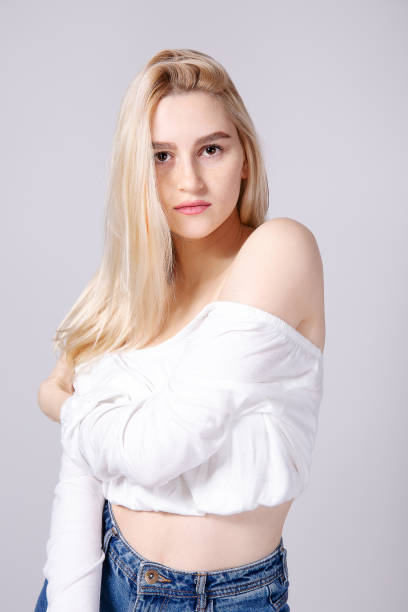 istock Attractive young woman posing over grey background. 1143233452