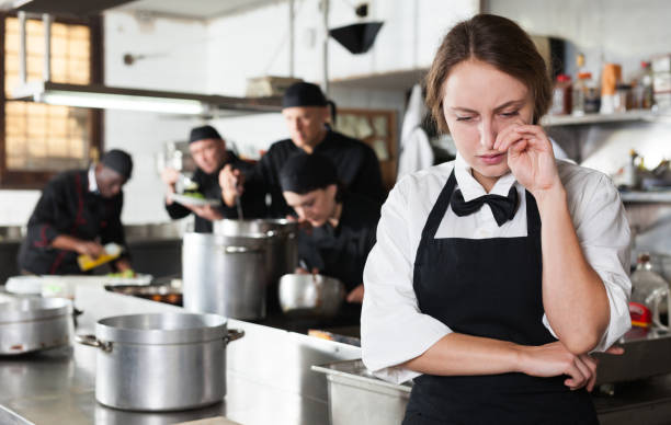 istock Tired and upset waitress in kitchen of restaurant 1143234756