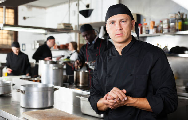 istock Confident male chef posing at restaurant kitchen 1143234771